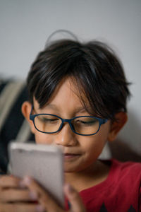 Close-up of boy using smartphone