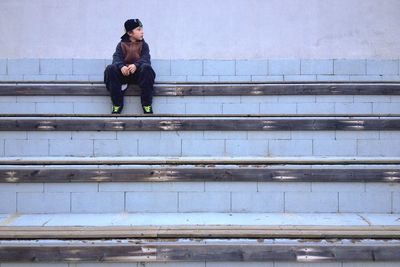 Full length of woman standing on bench