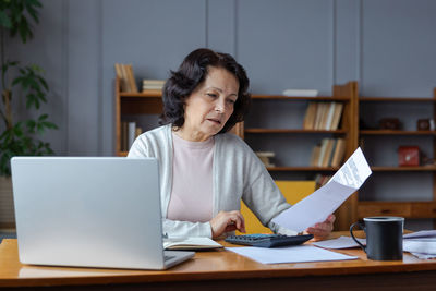 Young woman using laptop at home
