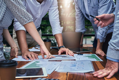 Midsection of business colleagues working in office