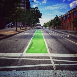 Road by city against sky