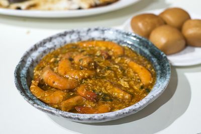 Close-up of prawns with gravy in plate on table