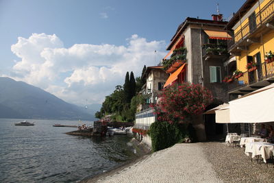 Scenic view of sea by buildings against sky