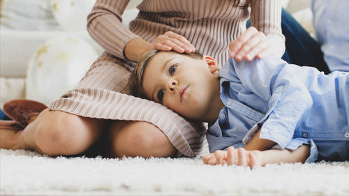 Mother and baby lying on bed