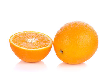 Close-up of orange fruit against white background