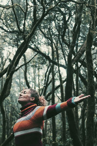 Low angle view of woman standing against trees