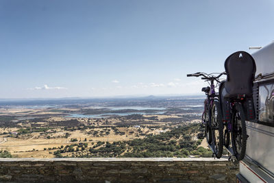 Bicycle by sea against sky