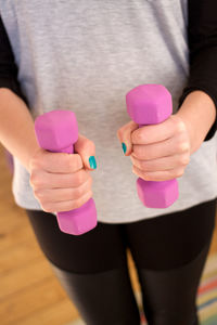 Close-up of hand holding pink wall