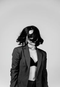 Young woman standing against white background