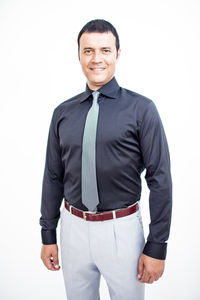 Portrait of a smiling man standing against white background