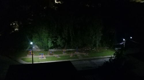 View of illuminated park at night