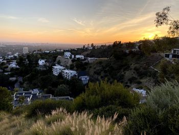 Scenic view of townscape against sky during sunset