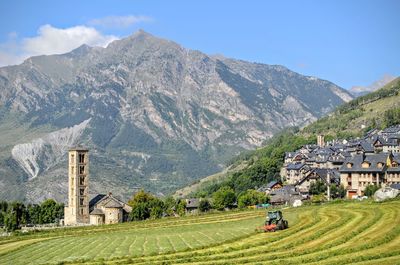 Scenic view of houses and mountains against sky