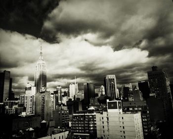 Cityscape against cloudy sky