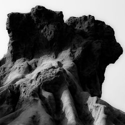 Low angle view of rock formation against sky