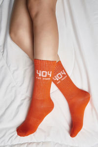 Low section of woman legs on bed