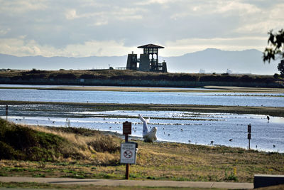 Lifeguard hut by sea against sky