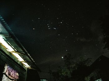 Low angle view of trees against sky at night