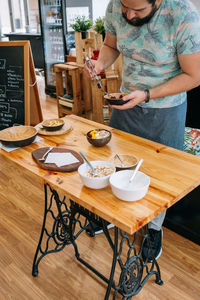 Midsection of woman preparing food on table