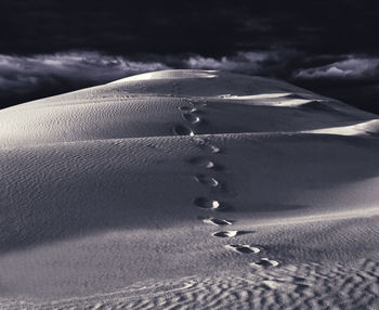 Close-up of sand against sky