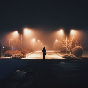 Cropped image of person holding chainlink fence