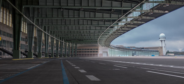 Empty road leading towards building