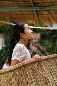 Side view of woman looking at  the roof 