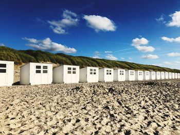 Houses on beach against sky