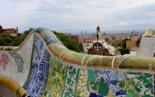 Mosaic tile bench at park guell against sky