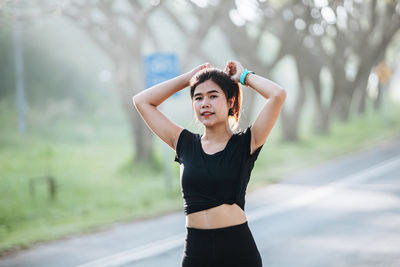 Young woman exercising on road