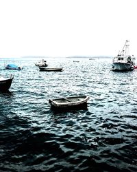 Boat sailing in sea against clear sky