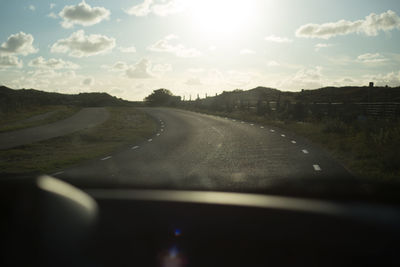 Empty road along countryside landscape