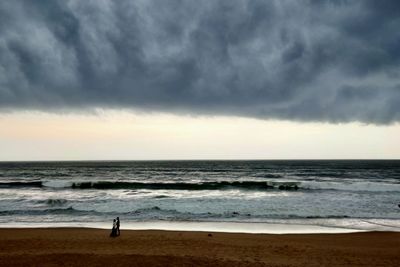 Scenic view of sea against cloudy sky