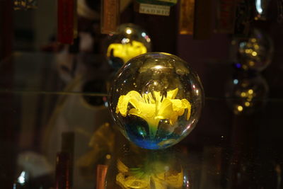 Close-up of yellow ball in glass