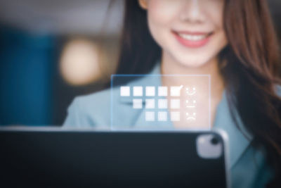 Portrait of young woman using laptop