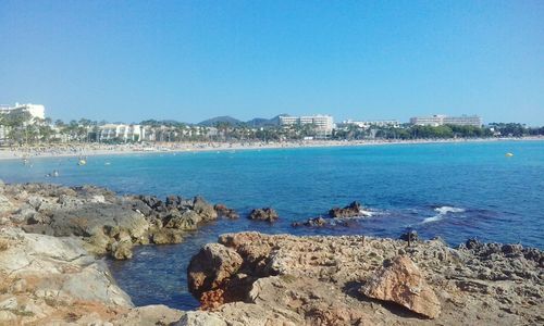 Scenic view of sea against clear blue sky