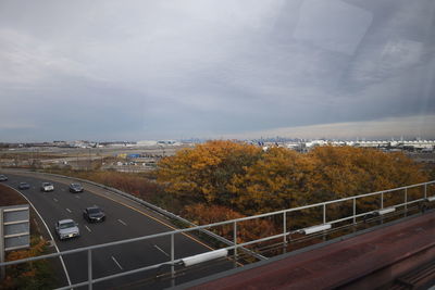 High angle view of road by trees against sky