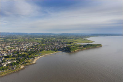 High angle view of sea and cityscape against sky