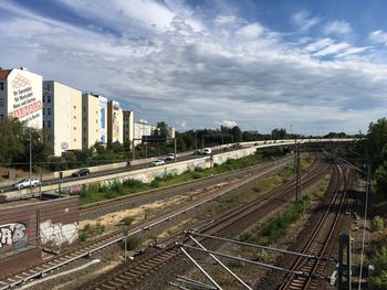 Railway tracks against sky in city