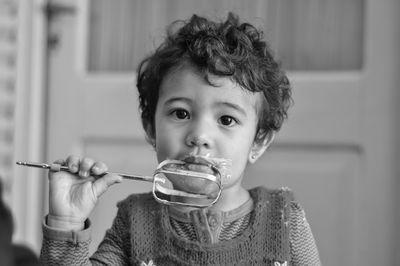 Close-up of young woman drinking milk at home