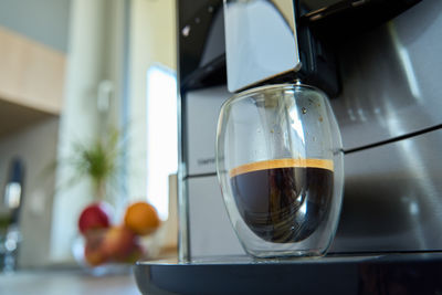 Coffee machine with fresh espresso in glass cup