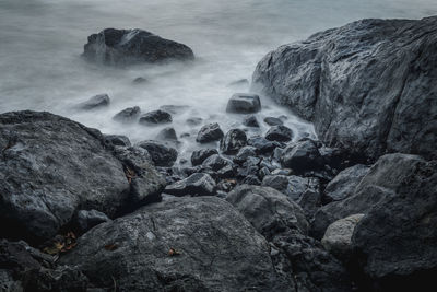 Rocks on beach against sky