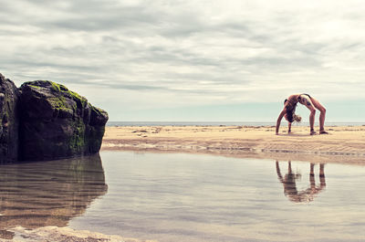 Man standing on beach against sky