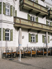 Chairs and tables on street by building