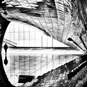 Digital composite image of person walking on modern building