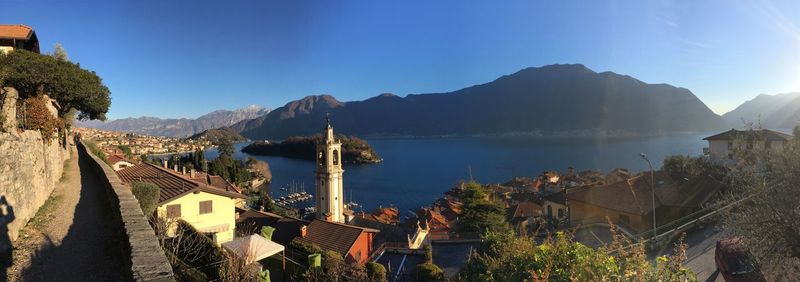 Panoramic view of city by sea against sky