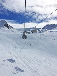 High angle view of ski lift over snowcapped mountains against sky