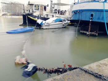 Boats moored at harbor