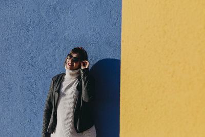 Woman standing against wall