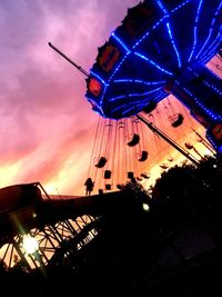 Silhouette of ferris wheel at dusk